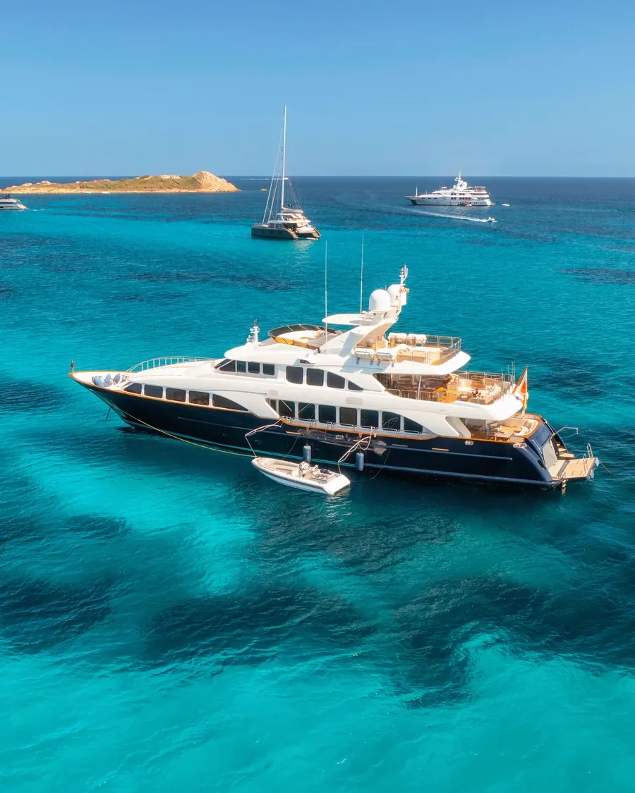 Luxury yacht at anchor in turquoise water